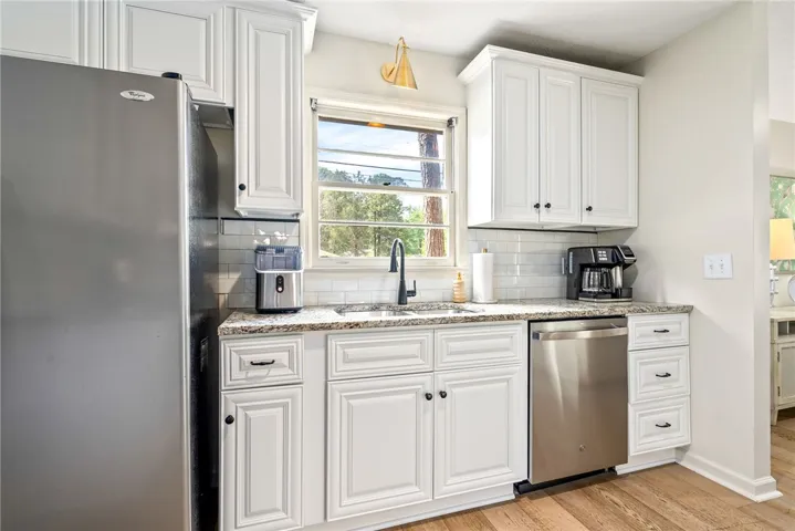 This bright kitchen features durable flooring and ample counter space, perfect for culinary endeavors.