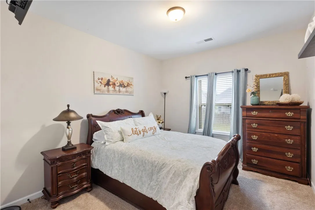 This inviting bedroom features ample natural light and a soothing atmosphere.