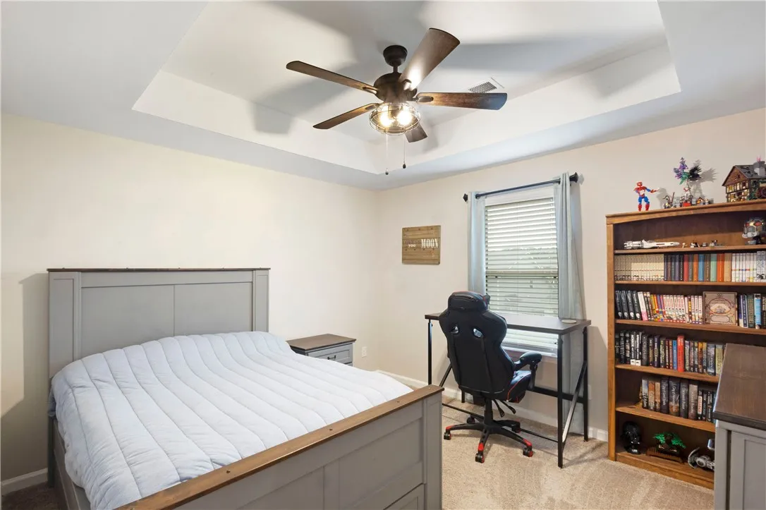 This tranquil bedroom offers comfort and natural light for restful living.