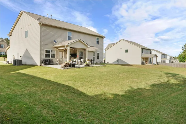 Enjoy outdoor living with a spacious yard and covered patio perfect for entertaining.