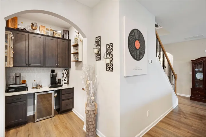 This inviting home features a convenient office nook and rich flooring, perfect for entertaining.