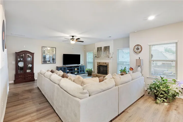 This inviting living space features warm floors and a cozy fireplace.