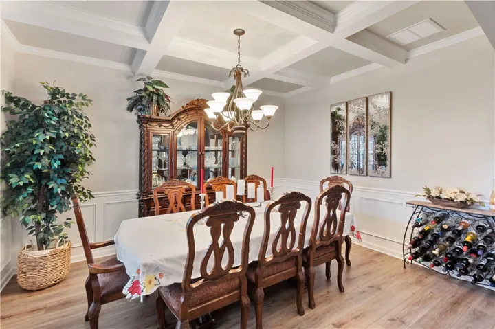 This elegant dining space features a chandelier and detailed ceiling, perfect for entertaining guests.