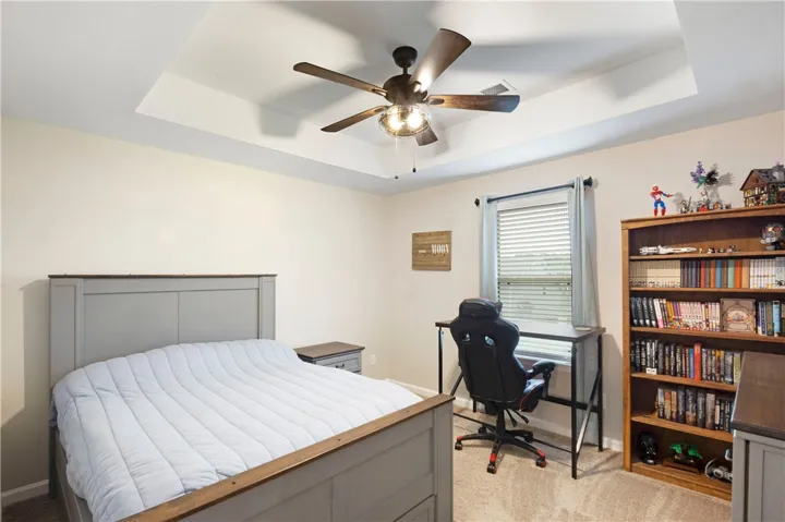 This tranquil bedroom offers comfort and natural light for restful living.