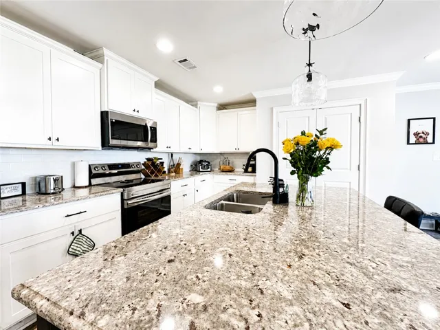This bright kitchen offers a practical layout for effortless culinary endeavors.