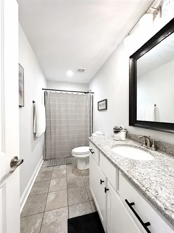This clean and bright bathroom features elegant finishes and a convenient layout.