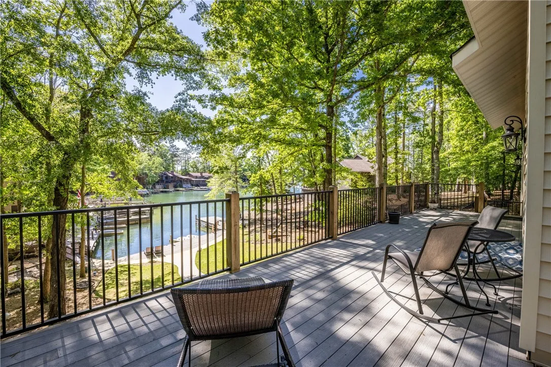 Enjoy tranquil lake views and lush surroundings from this inviting outdoor deck.