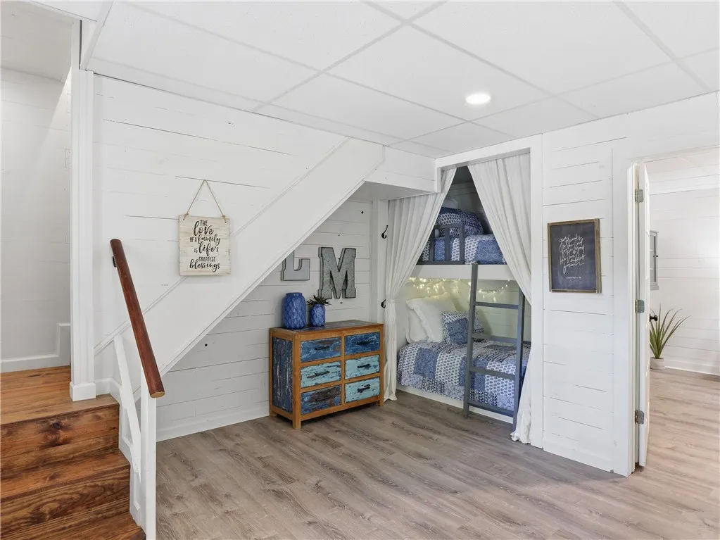 This versatile space features a built-in bunk area and warm wood flooring.