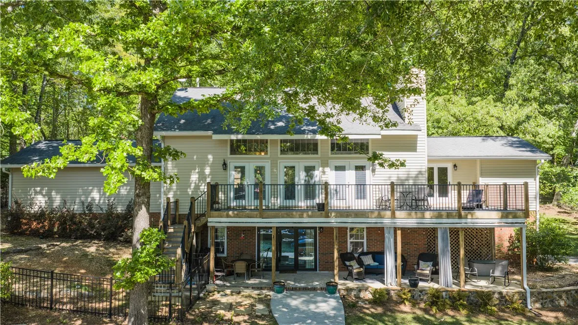 This home features a deck perfect for outdoor enjoyment, blending seamlessly with the surrounding trees.