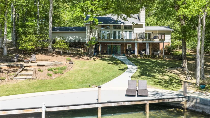 This lakeside home offers expansive outdoor living and direct water access, perfect for relaxation and recreation.