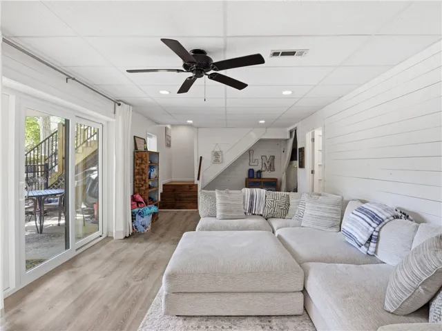 This inviting basement living space offers comfort and direct outdoor access.