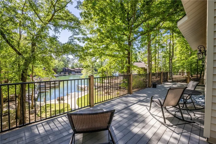Enjoy tranquil lake views and lush surroundings from this inviting outdoor deck.