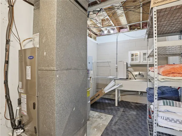 This functional basement area includes utility equipment and ample storage solutions.