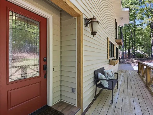 This inviting entrance features a warm wooden porch, perfect for greeting guests.