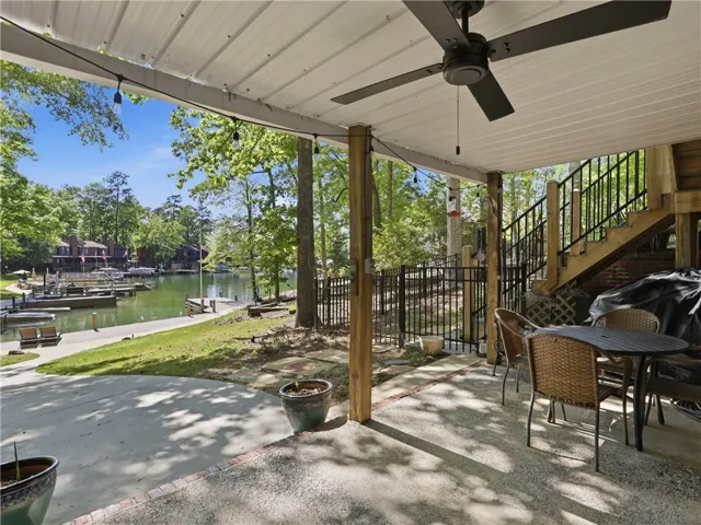 Enjoy tranquil waterfront views from this inviting outdoor patio, perfect for relaxing.