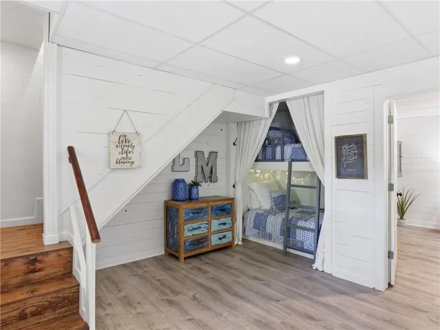 This versatile space features a built-in bunk area and warm wood flooring.