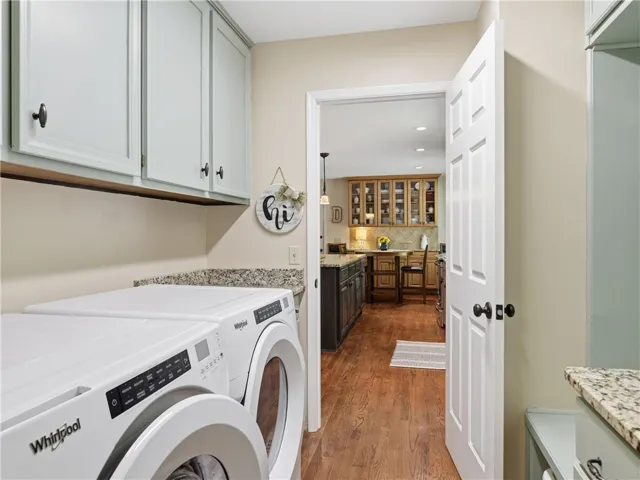 This functional laundry area features convenient appliances and easy access to the kitchen.
