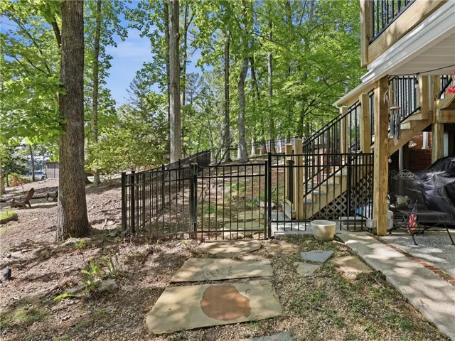 This tranquil setting features a wooded backyard and a multi-level deck perfect for outdoor enjoyment.