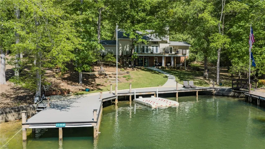 This serene lakefront residence offers direct water access and private boat docks.