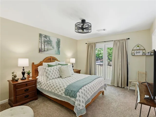 This serene bedroom offers a private outdoor retreat with direct balcony access.