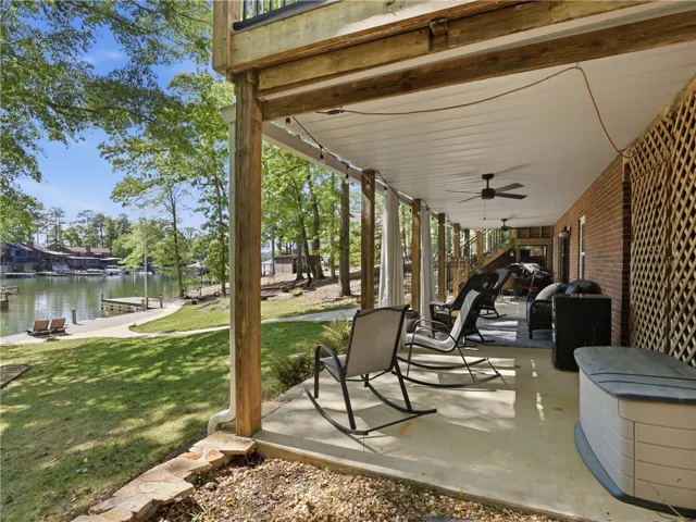 Enjoy serene lakeside living from this expansive covered patio, perfect for relaxation and entertaining.