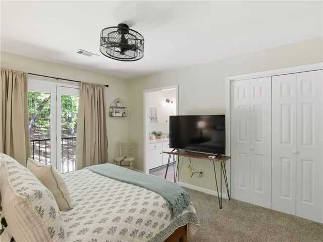 This restful bedroom features plush carpeting and convenient access to a private balcony.