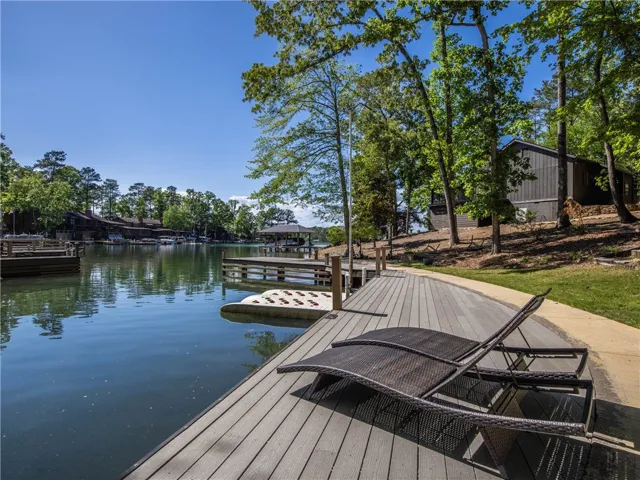 This serene lakefront property offers a private dock, perfect for enjoying tranquil water views.