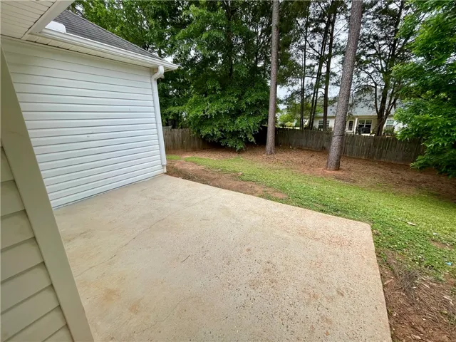 This spacious backyard offers privacy and room for outdoor enjoyment.