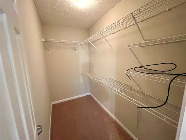 This spacious closet offers organized storage solutions for all your belongings.