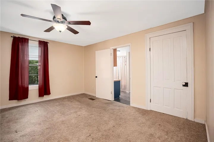 This spacious bedroom offers ample comfort and natural light.