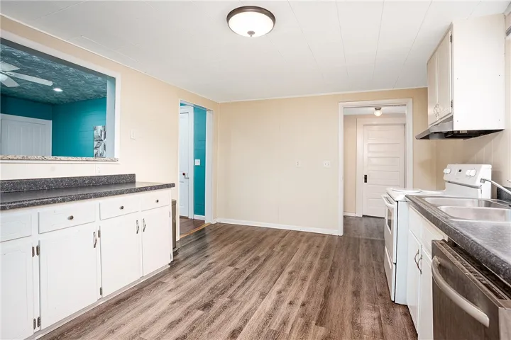 This spacious kitchen offers ample room for culinary endeavors and comfortable dining.