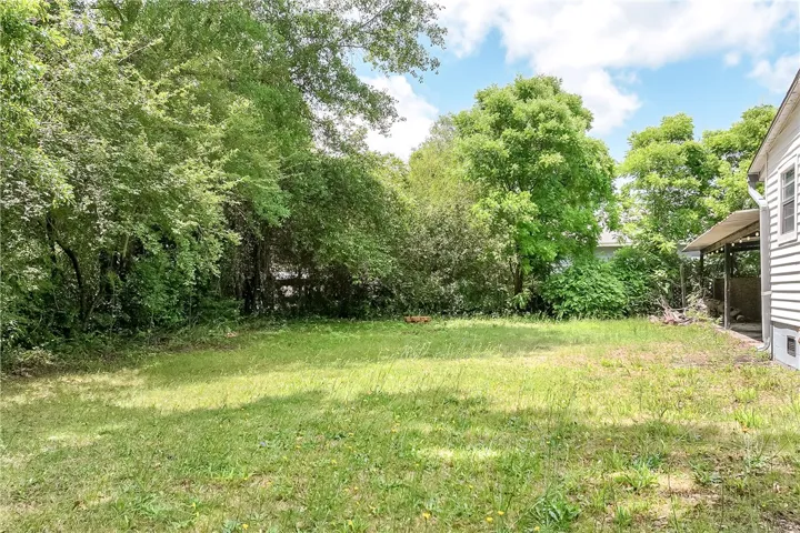 Expansive green space offers a serene outdoor retreat, perfect for relaxation and recreation.