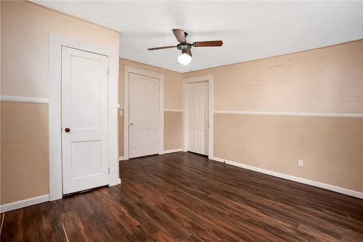 This inviting bedroom features rich wood flooring and classic architectural details.