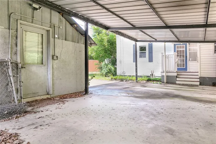 This outdoor space offers convenient covered parking and a functional entry point to the property.