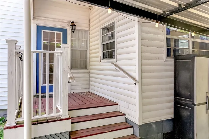 This inviting porch entry provides a warm welcome with its classic design and functional features.