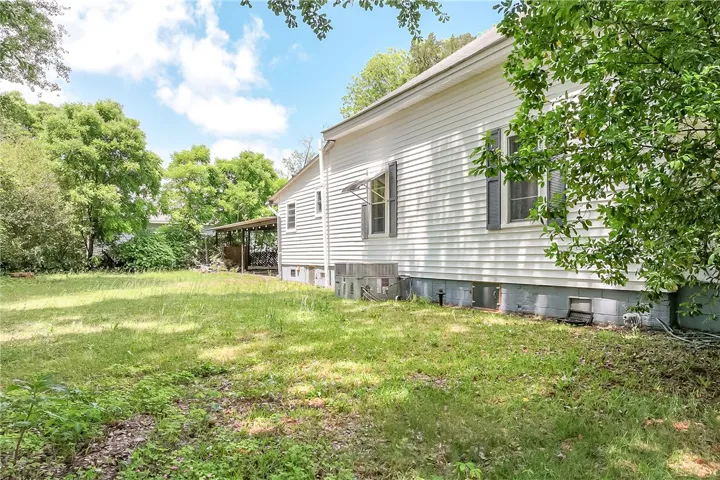 This property features a spacious yard and classic siding, creating an inviting outdoor atmosphere.