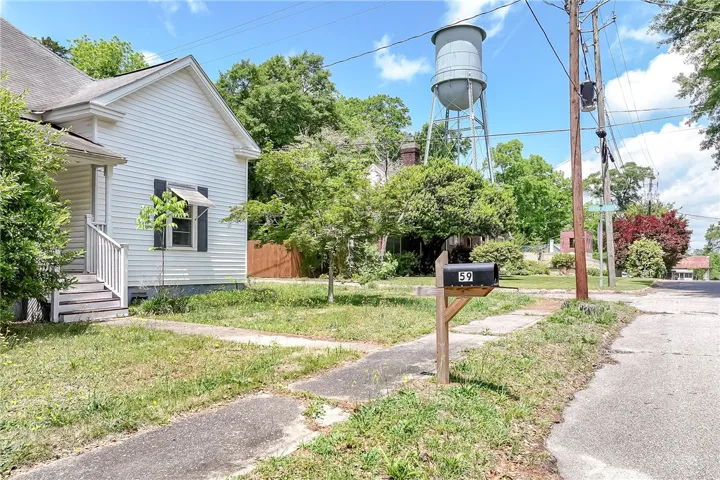 This charming home features a classic exterior and a spacious yard, offering comfortable living.