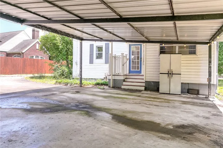 This charming home offers convenient covered parking and a welcoming entrance.