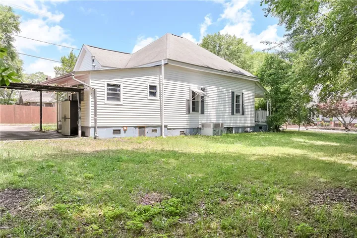 This classic white home with a grassy yard and ample parking awaits its next owner.
