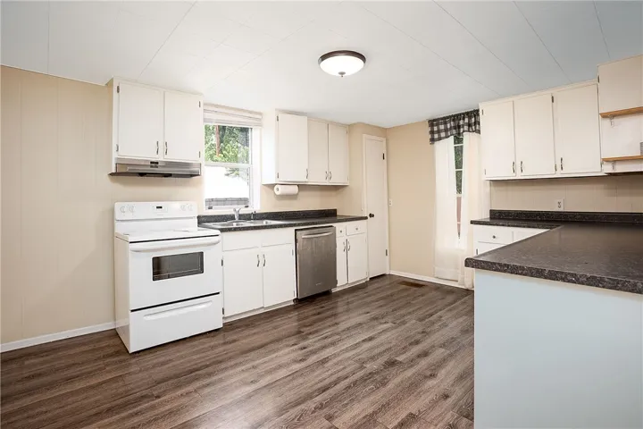 This bright kitchen features ample cabinetry and durable flooring for daily living.
