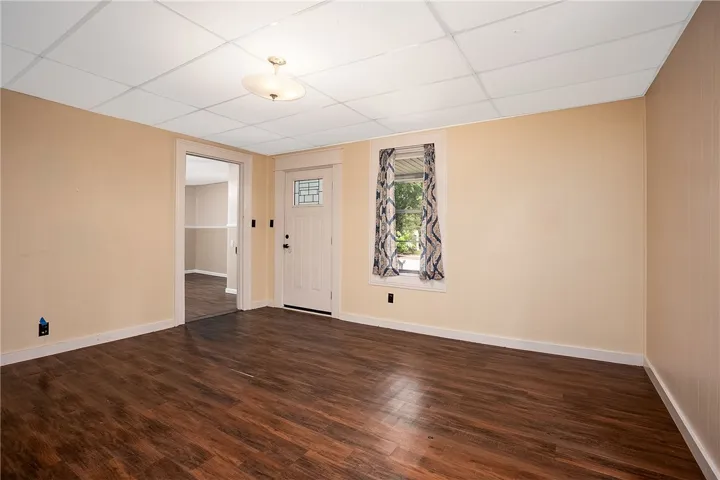 This inviting room features warm wood flooring and a classic door, ready for your personal touch.
