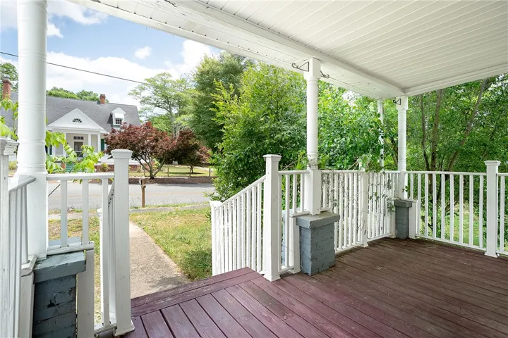 Welcome to a charming residence featuring a classic porch, perfect for relaxing outdoors.