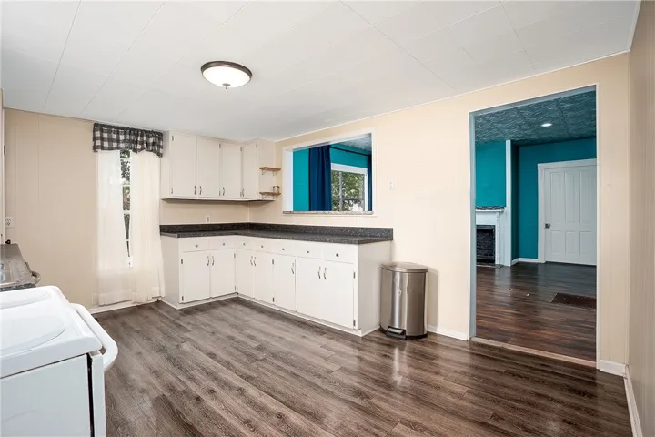 This spacious kitchen offers ample cabinet and counter space, ideal for culinary creations and casual dining.