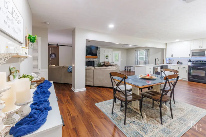 An inviting open-concept living space features warm wood floors and abundant natural light.