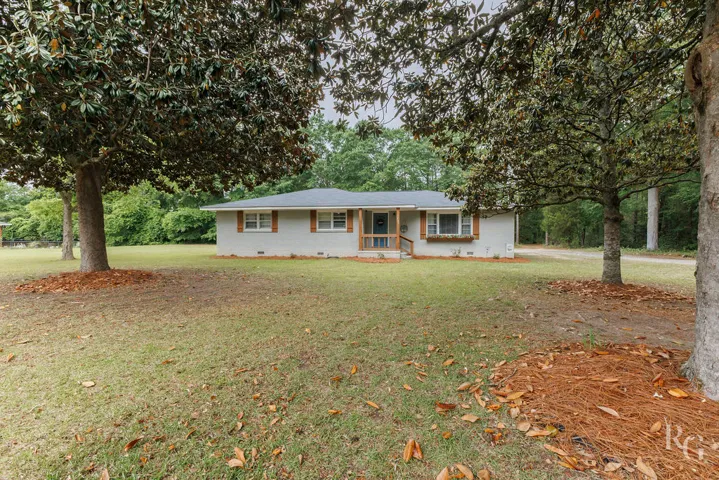 Charming home with ample yard space and natural surroundings.