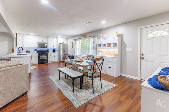 This inviting space combines a functional kitchen with an adjacent dining area, perfect for everyday living.