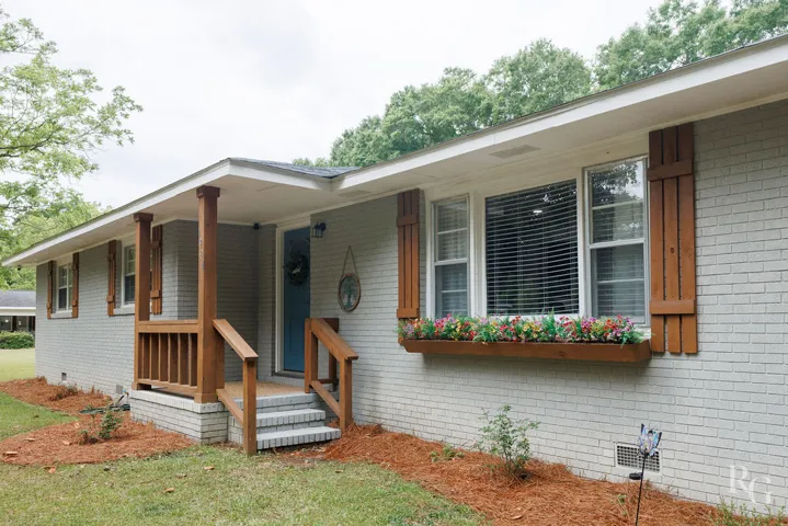This charming home features a brick exterior and a welcoming front porch, perfect for outdoor enjoyment.