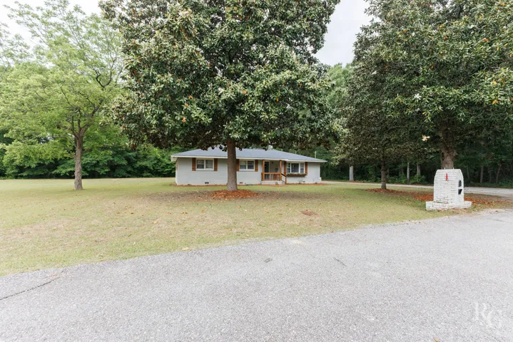 This charming residence offers a peaceful retreat with abundant green space.