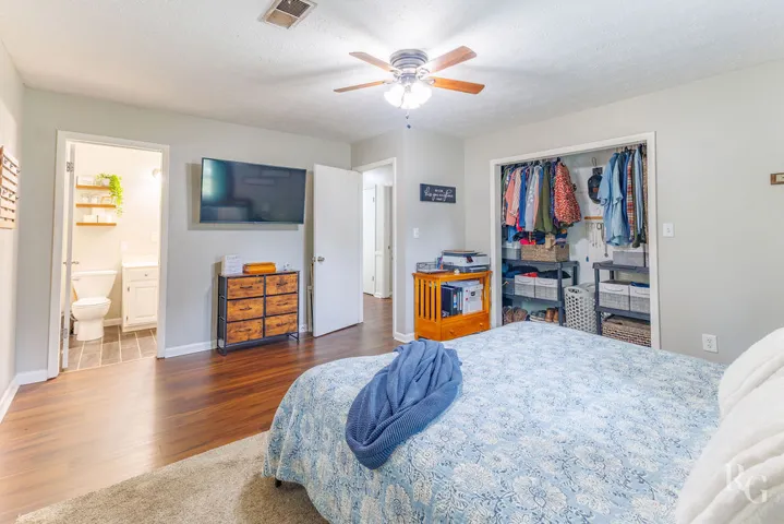 This primary bedroom suite offers a tranquil retreat with convenient access to an adjacent bathroom.