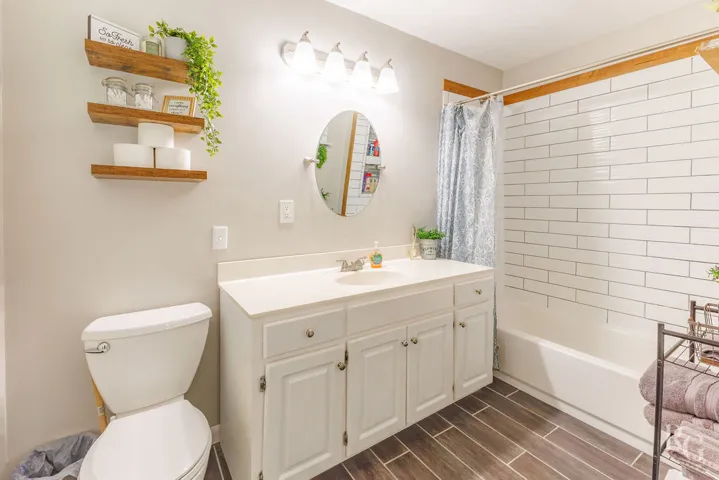 This bathroom features a contemporary vanity and stylish subway tile shower surround.